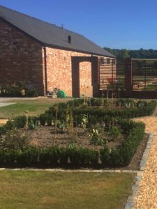 Barn conversion with square flowerbeds